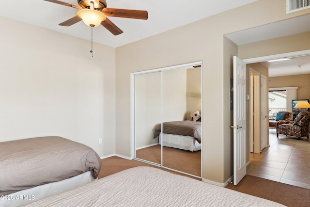 9555 E Raintree Dr E Unit 2061, Scottsdale, AZ 85260 - carpeted bedroom with a closet, visible vents, baseboards, and ceiling fan