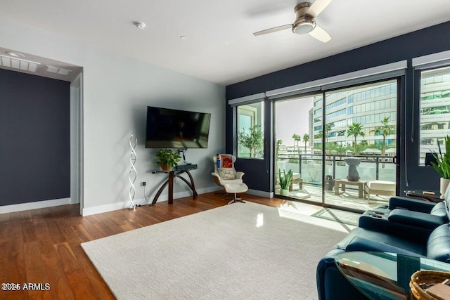 living room with dark hardwood / wood-style floors and ceiling fan