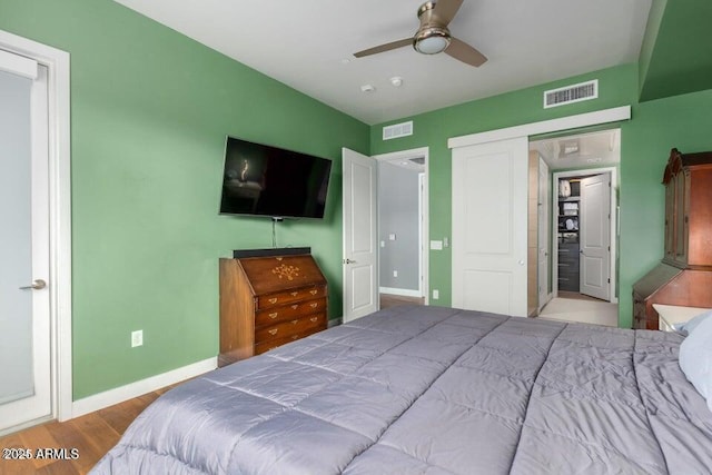 bedroom featuring ceiling fan, light hardwood / wood-style floors, and a closet