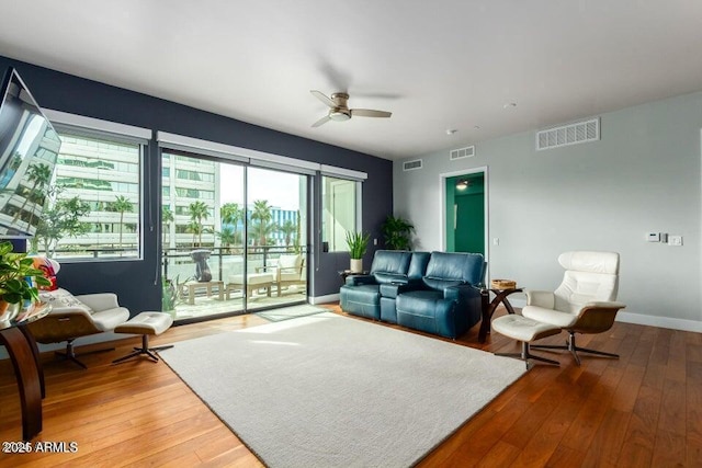 living room with hardwood / wood-style floors and ceiling fan