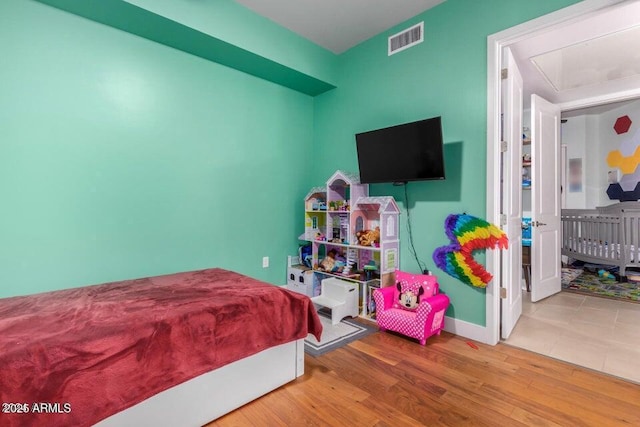 bedroom with hardwood / wood-style floors