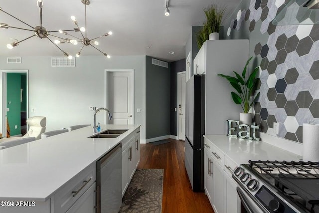 kitchen featuring white cabinetry, sink, dark wood-type flooring, and dishwasher