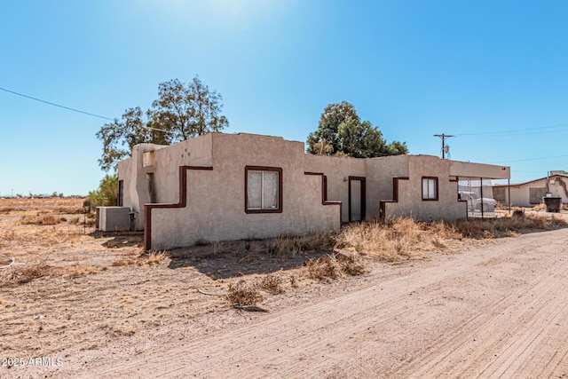 view of property exterior with central AC