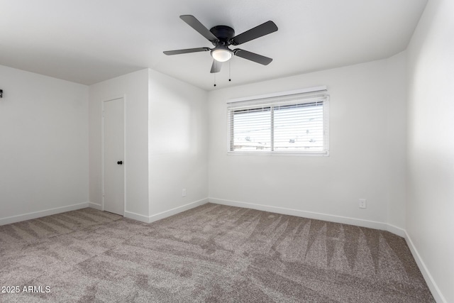 carpeted empty room with baseboards and a ceiling fan