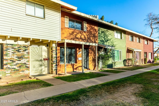 view of property featuring brick siding