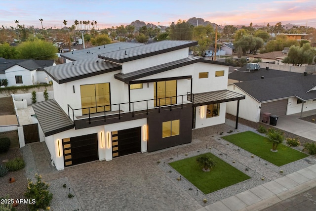 exterior space with a garage and a balcony