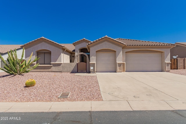 11312 E Enrose St, Mesa, AZ 85207 - mediterranean / spanish home with a garage, stucco siding, and concrete driveway