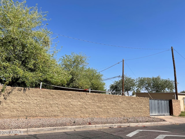 exterior space with a gate and curbs