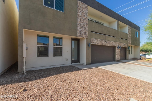 2000 N 36th St Unit 41, Phoenix, AZ 85008 - view of front facade with stone siding, concrete driveway, an attached garage, and stucco siding