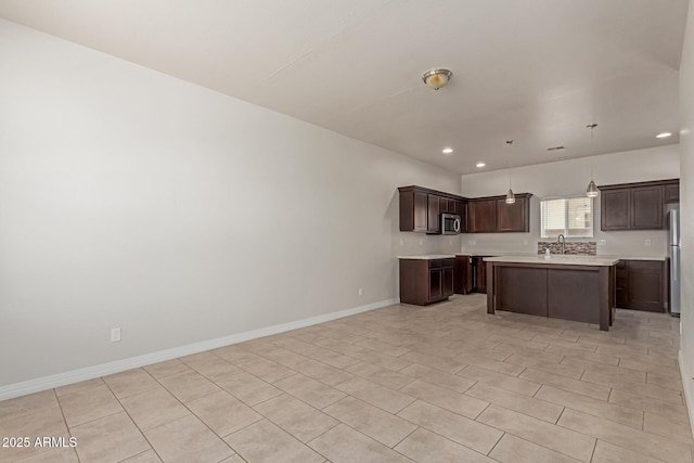 2000 N 36th St Unit 41, Phoenix, AZ 85008 - kitchen featuring stainless steel appliances, light countertops, recessed lighting, dark brown cabinets, and a center island