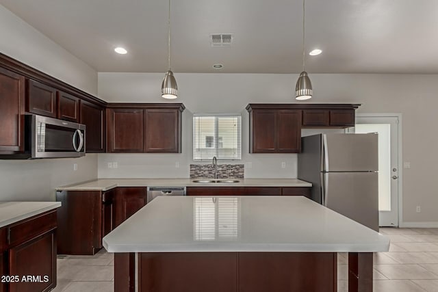 2000 N 36th St Unit 41, Phoenix, AZ 85008 - kitchen featuring appliances with stainless steel finishes, light tile patterned floors, hanging light fixtures, a kitchen island, and recessed lighting
