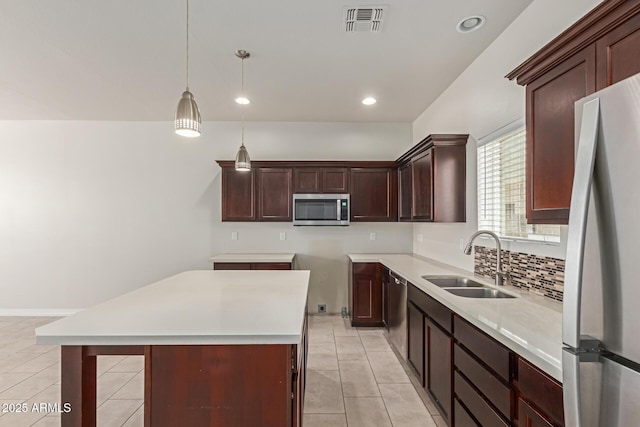 2000 N 36th St Unit 41, Phoenix, AZ 85008 - kitchen featuring appliances with stainless steel finishes, light tile patterned floors, hanging light fixtures, a center island, and recessed lighting