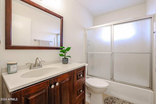 full bathroom featuring shower / bath combination with glass door, vanity, and toilet