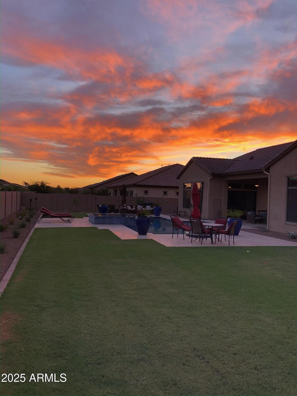 yard at dusk with a patio area