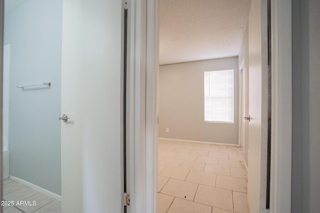 bathroom with baseboards and a textured ceiling