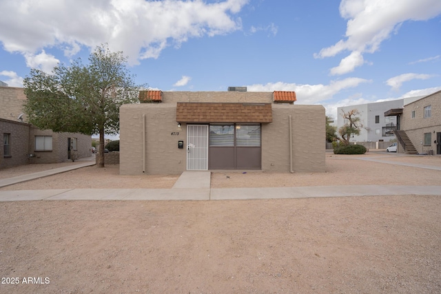 pueblo-style house with stucco siding