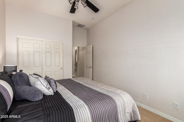 carpeted bedroom featuring baseboards, a closet, and ceiling fan