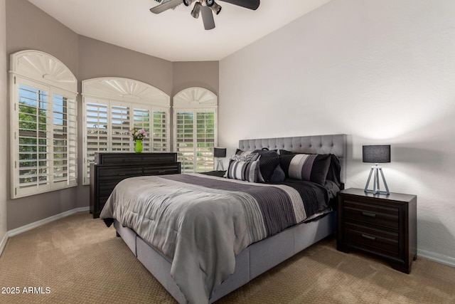 carpeted bedroom featuring baseboards and a ceiling fan