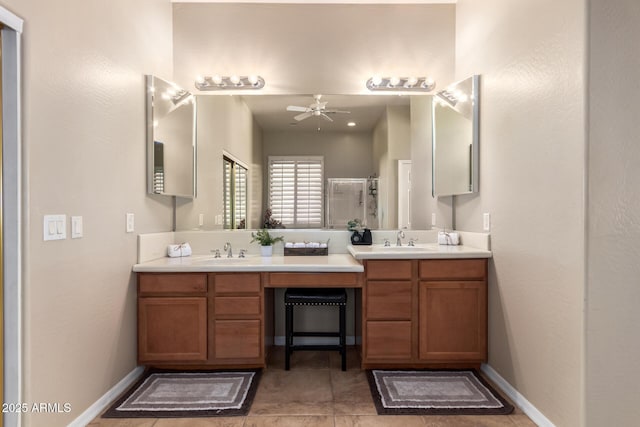 full bath with a stall shower, a ceiling fan, double vanity, and tile patterned flooring