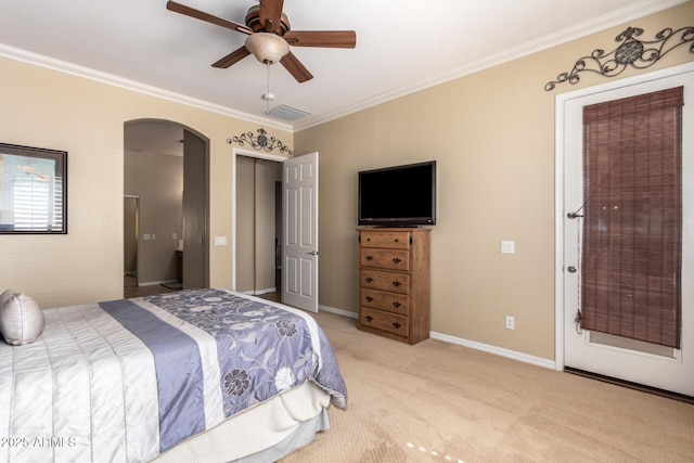 bedroom with arched walkways, crown molding, light carpet, and a ceiling fan