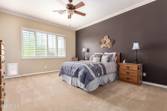 carpeted bedroom with crown molding, baseboards, and a ceiling fan