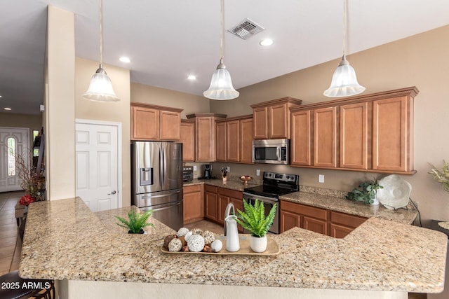 kitchen featuring stainless steel appliances, brown cabinets, light stone countertops, and recessed lighting