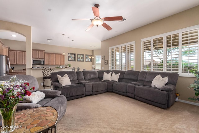 living room with light colored carpet and ceiling fan
