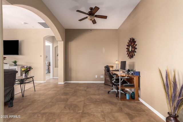 office featuring arched walkways, a ceiling fan, baseboards, and lofted ceiling