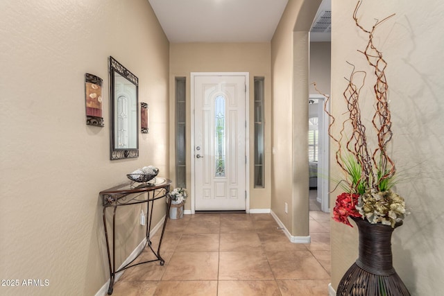 entrance foyer with light tile patterned floors and baseboards