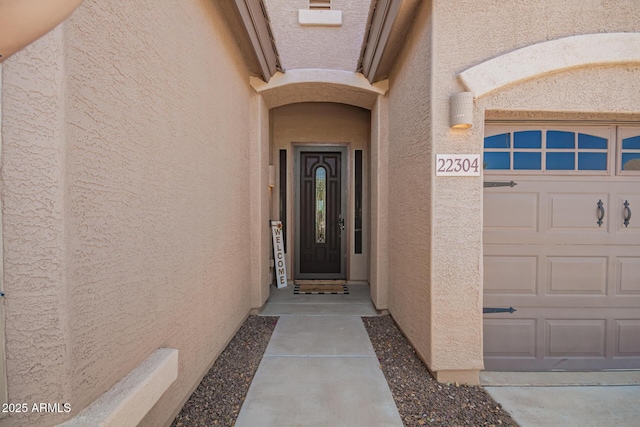 doorway to property with stucco siding