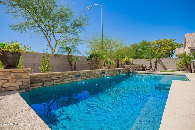 view of swimming pool with a fenced backyard