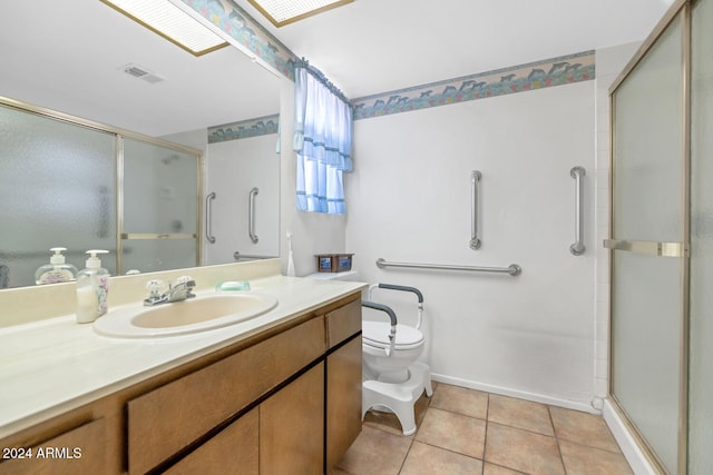 bathroom with vanity, a skylight, tile patterned flooring, toilet, and walk in shower