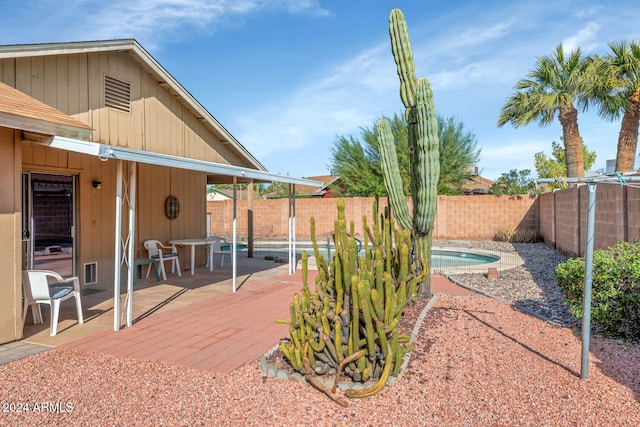 view of yard featuring a fenced in pool and a patio