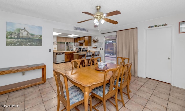 dining space with ceiling fan, light tile patterned floors, and a textured ceiling