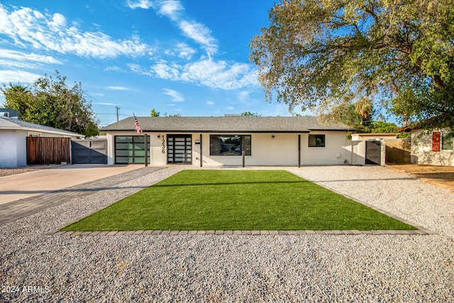 ranch-style house featuring a front lawn