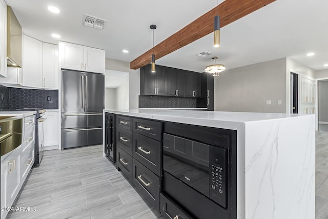 kitchen featuring white cabinetry, decorative light fixtures, appliances with stainless steel finishes, beamed ceiling, and decorative backsplash