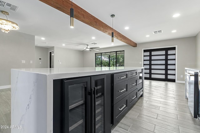 kitchen featuring a spacious island, decorative light fixtures, beam ceiling, and wine cooler