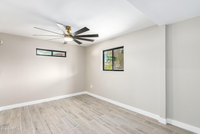 unfurnished room featuring ceiling fan, light hardwood / wood-style floors, and a wealth of natural light