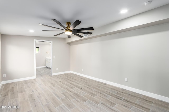 empty room with ceiling fan and light wood-type flooring