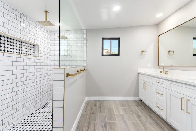 bathroom featuring vanity and tiled shower