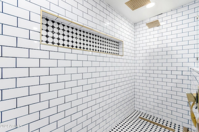 bathroom with a tile shower