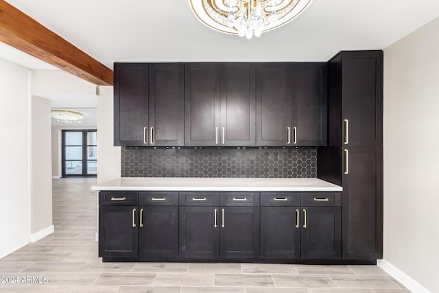 kitchen featuring tasteful backsplash and beamed ceiling