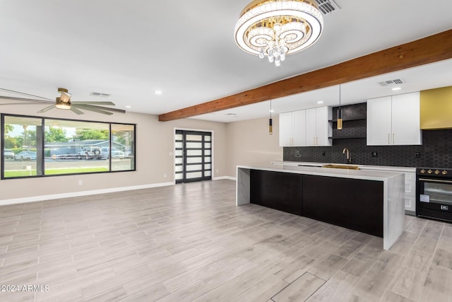 kitchen with white cabinetry, tasteful backsplash, decorative light fixtures, a center island, and black range with electric stovetop