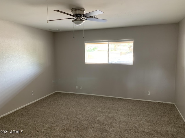 empty room with carpet floors, ceiling fan, and baseboards