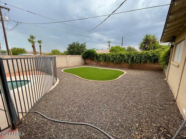 view of yard with a fenced backyard, a fenced in pool, and a patio