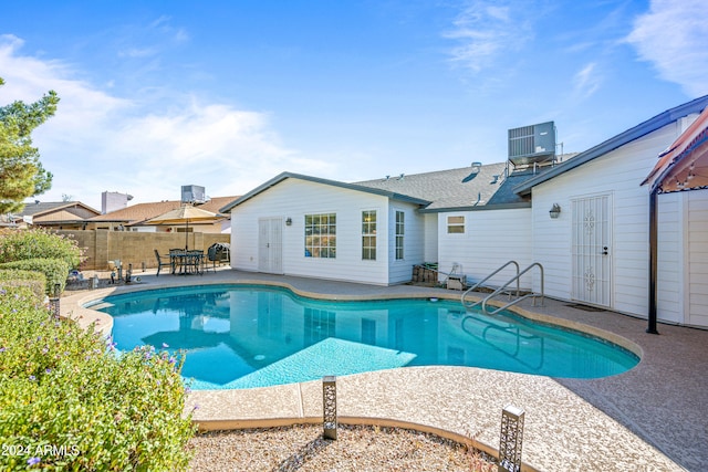 view of pool with central AC unit and a patio area