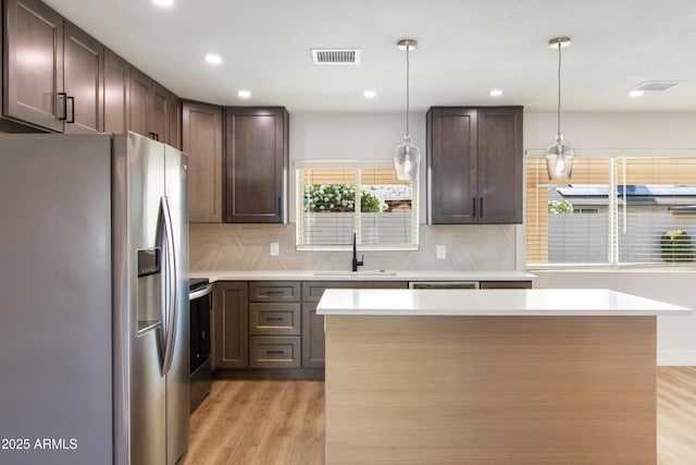 2329 S Elm, Mesa, AZ 85202 - kitchen featuring stainless steel fridge, a sink, light wood-style floors, decorative backsplash, and recessed lighting