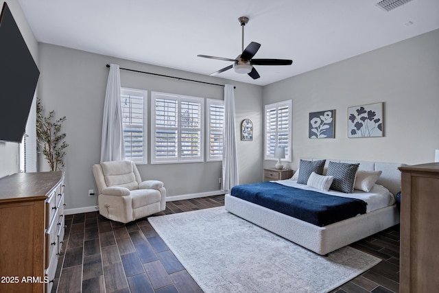 bedroom with visible vents, a ceiling fan, dark wood finished floors, and baseboards