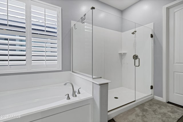 bathroom with a bath and a stall shower