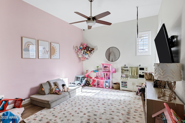 rec room with a ceiling fan and wood finished floors